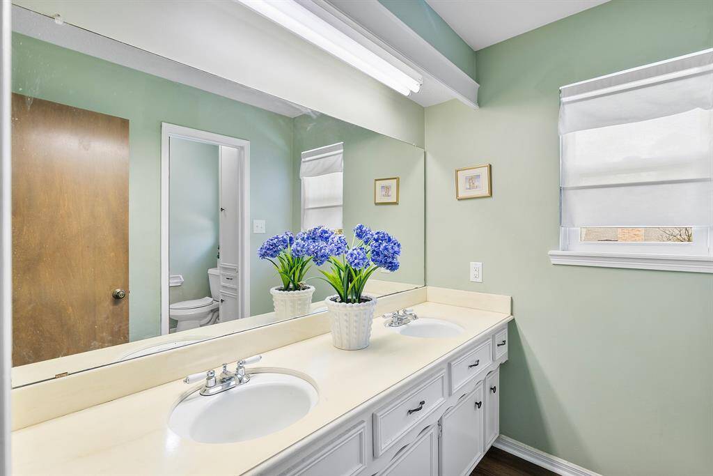 The second bedroom features dual sinks, ample counter space, abundant storage, and new flooring.