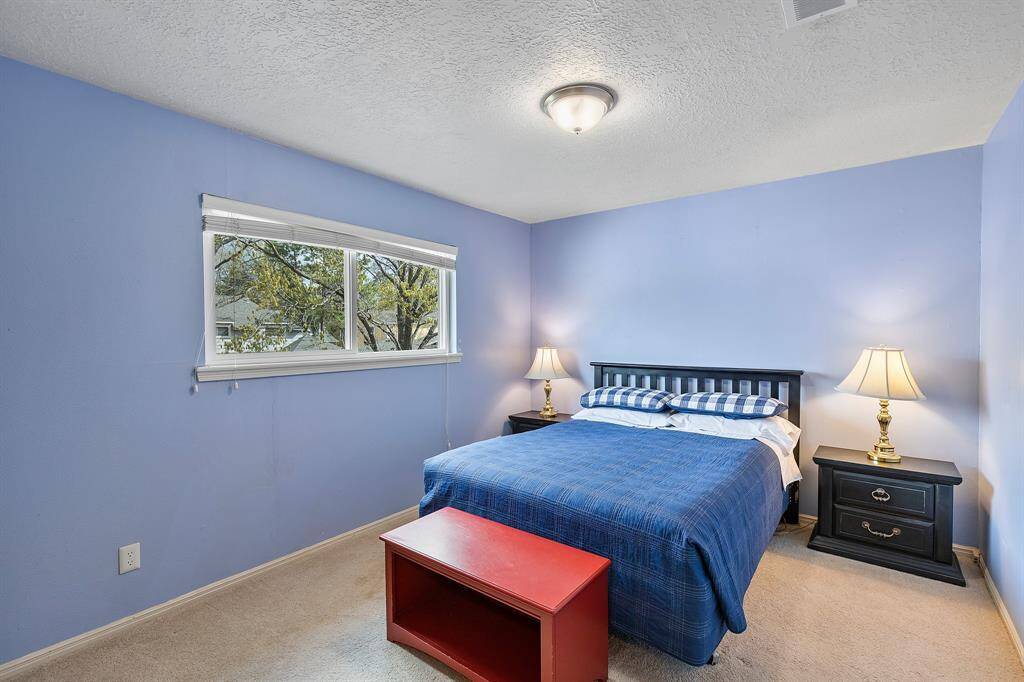 Spacious fourth bedroom with a large closet and bright windows.