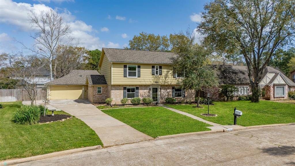 Grand lot of 10,000 sq feet with beautiful mature trees and a large driveway for ample parking.