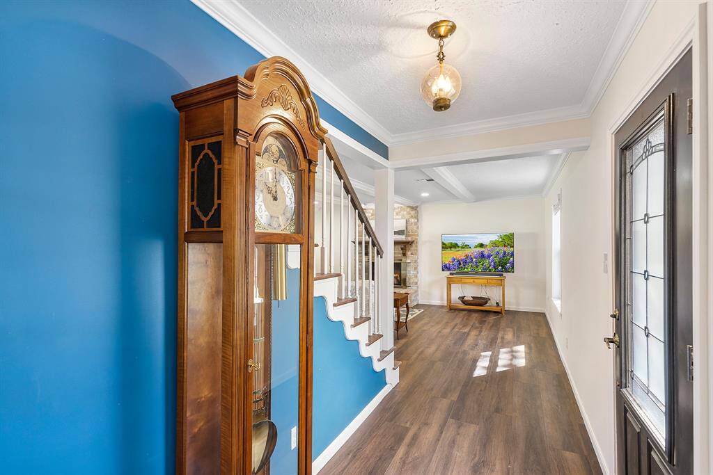 Welcome to your inviting new home, featuring a charming entryway with elegant details and warm, stylish flooring.