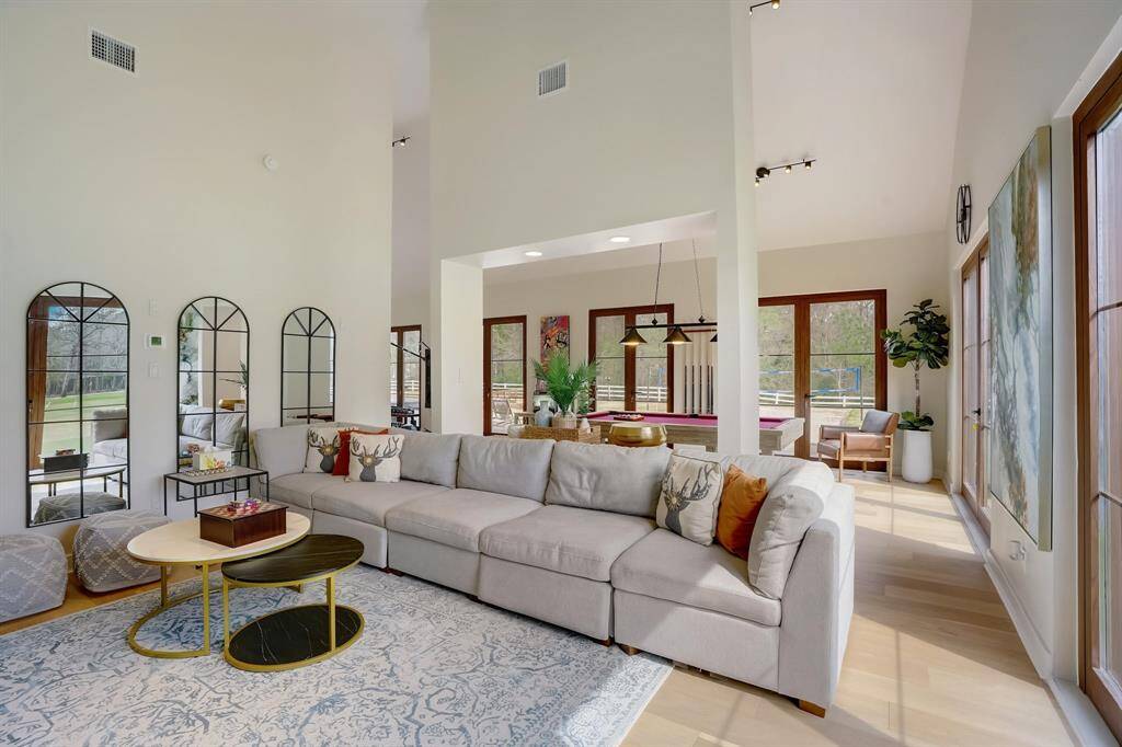 A welcoming living room that leads straight to your personal fitness retreat and pool table.