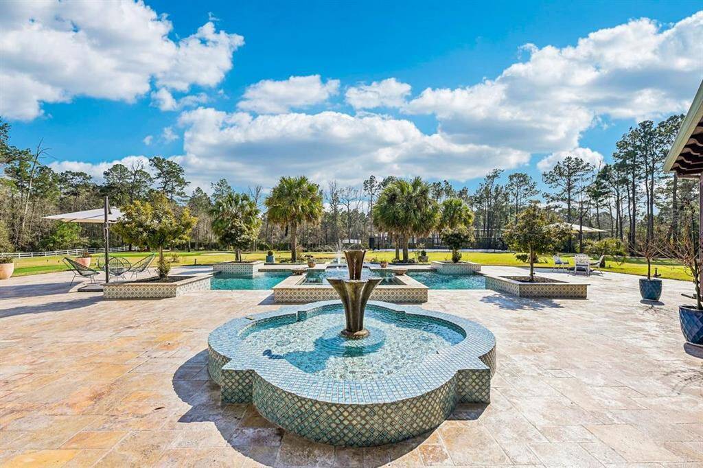 Elegant fountain by the pool, adding a touch of serenity and luxury to your outdoor oasis.