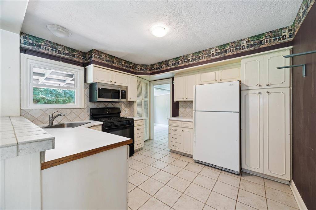 This kitchen has a pantry and storage closet plus ample counter space.