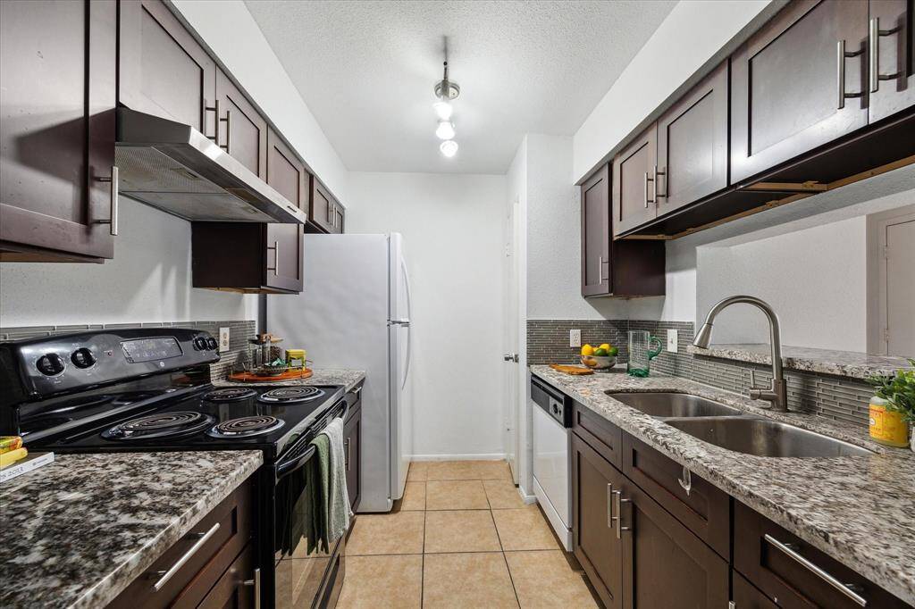 The thoughtfully designed kitchen boasts granite countertops, a spacious pantry, and includes all appliances—providing everything you need, whether you're enjoying a cozy night in or hosting a crowd.