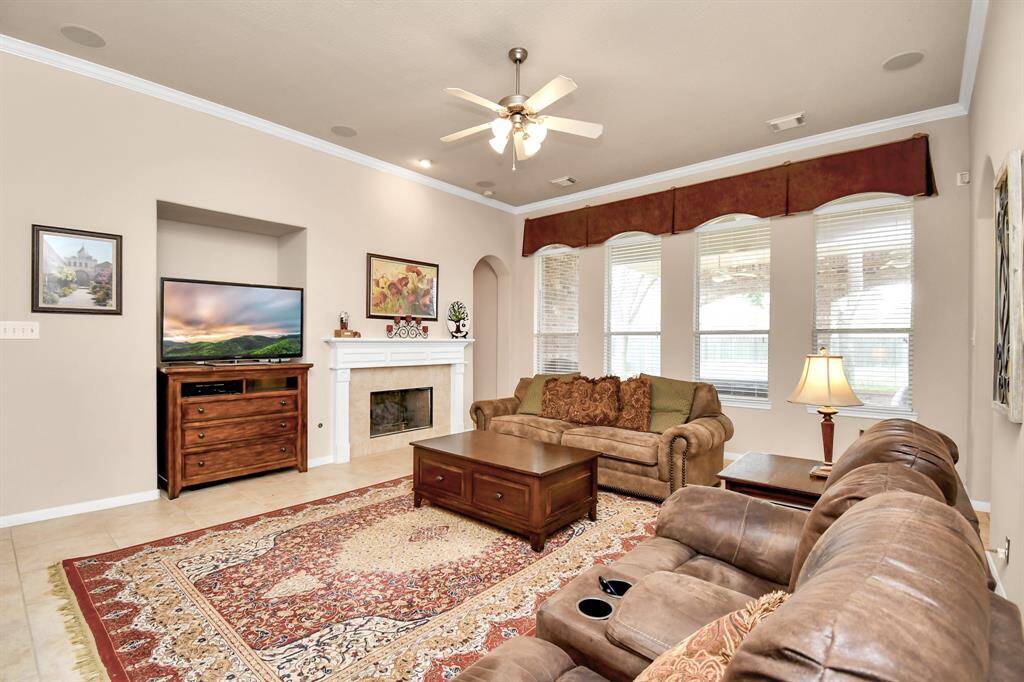 The den is spacious enough to accommodate oversized furniture and features a focal point fireplace, creating a cozy and inviting atmosphere for relaxation and gatherings.
