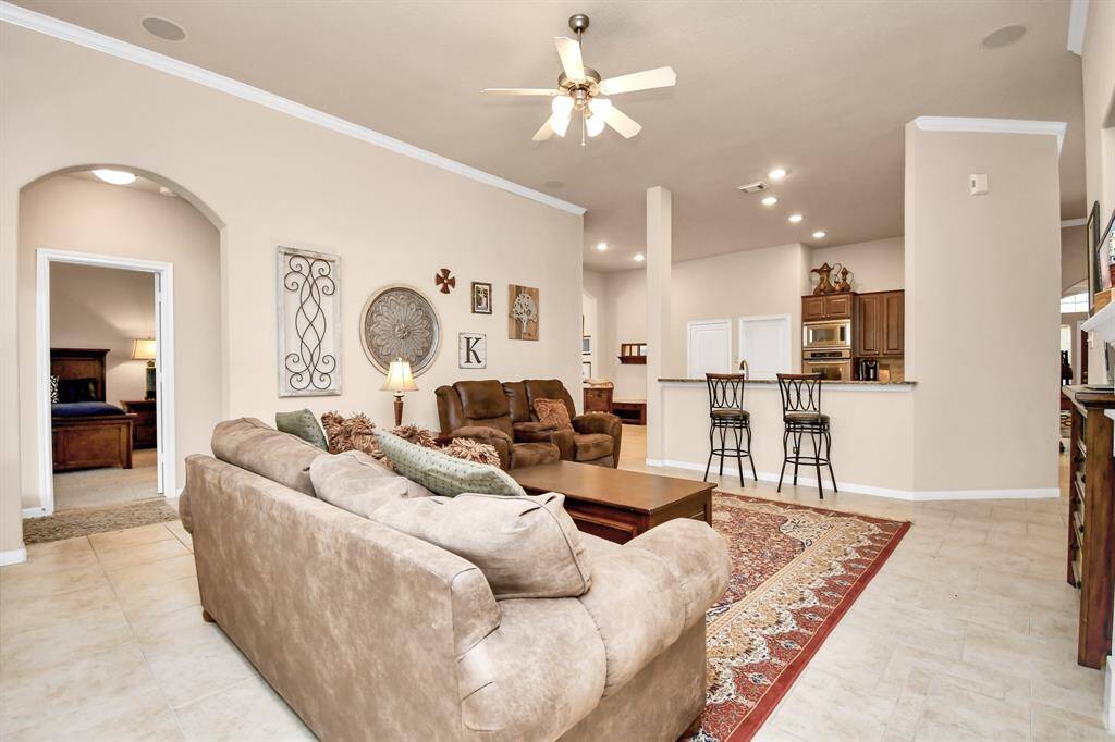This photo showcases the openness of this area. Notice the breakfast bar, providing additional seating and enhancing the space's functionality.