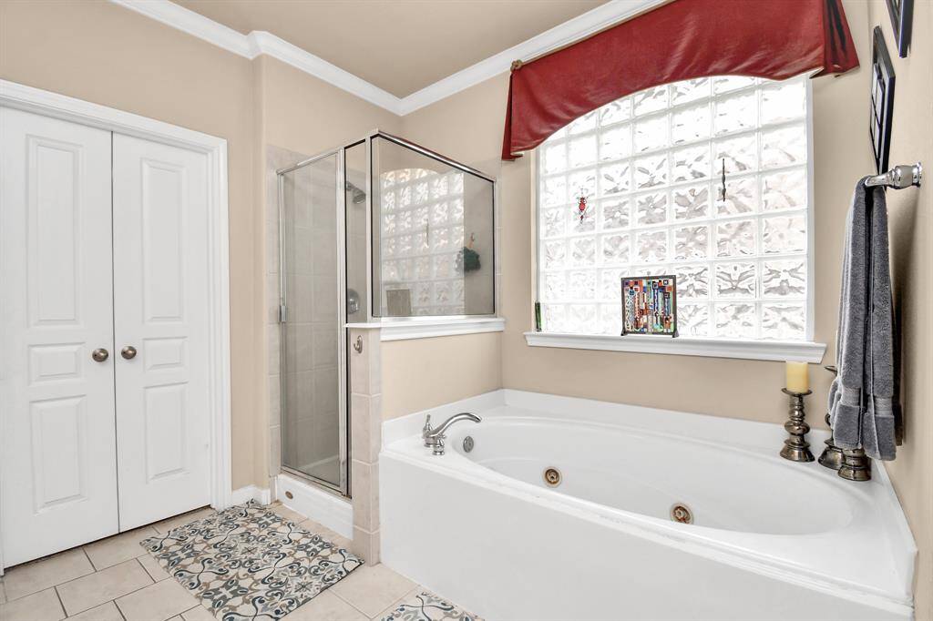 In the primary bathroom, you have the option to choose between a leisurely soak in the jetted tub or the refreshing sensation of a hot shower, providing the flexibility to indulge in your preferred mode of relaxation.