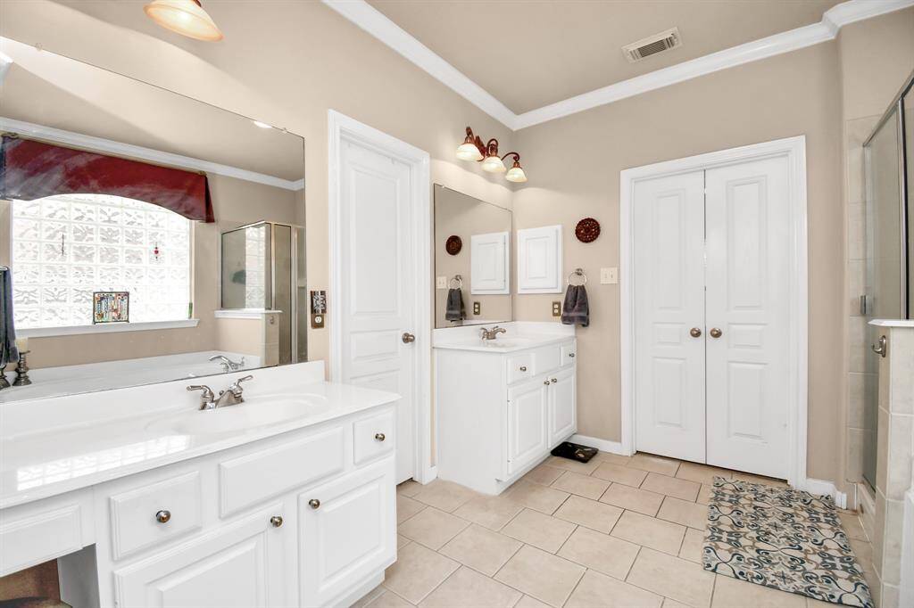 Dual sinks and a dedicated vanity area for makeup application offer practicality and convenience, allowing you to keep your belongings separate and enjoy your own personalized space within the primary bathroom.