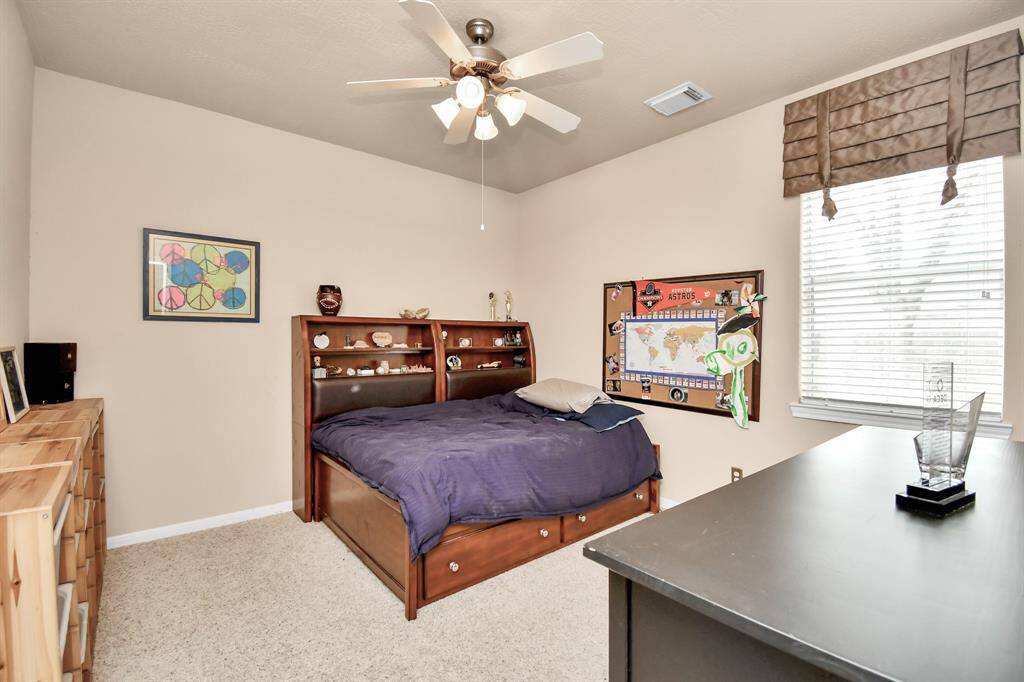 This is one of the three secondary bedrooms in this home. All bedrooms are generously sized and offer excellent closet space, ensuring comfort and functionality for all occupants.