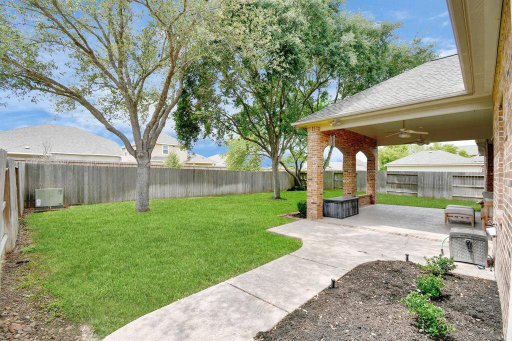There is yard for kids or even adults to play and pets to roam. A sidewalk leads to the side of the home,