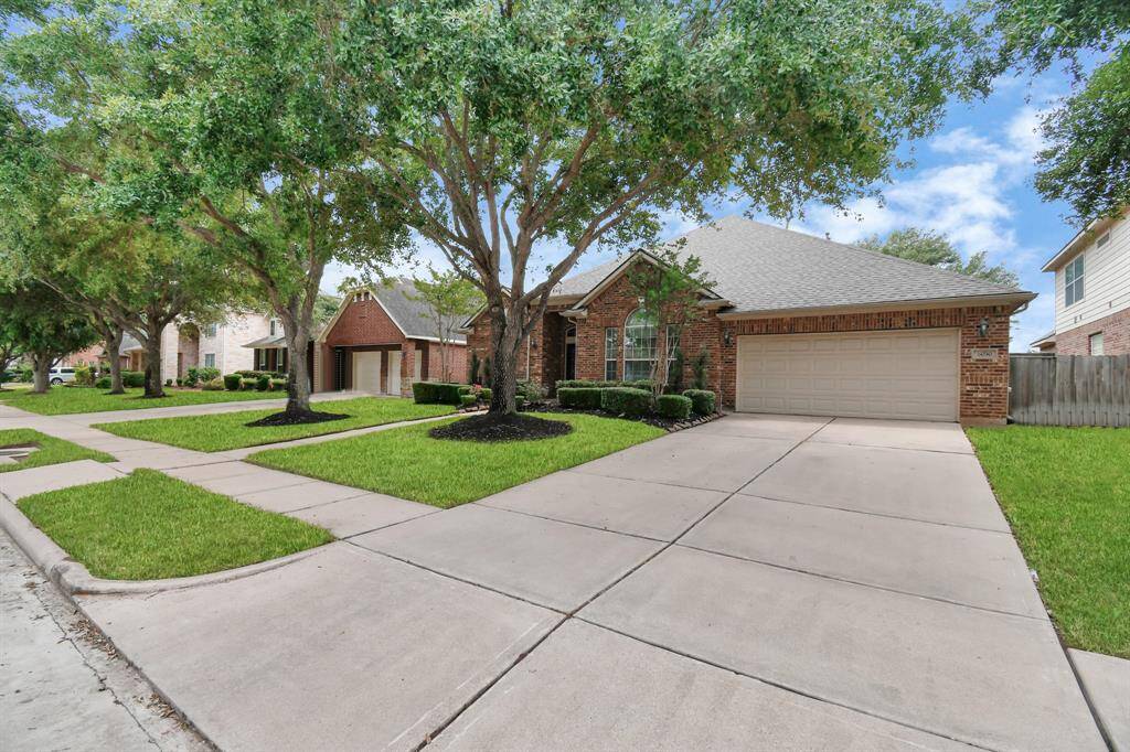 Mature trees grace the front yard, adding to the charm and character of this beautiful home.