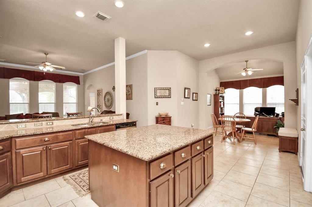 Across the hallway from the dining room lies this magnificent gourmet kitchen, complete with an incredible massive island.