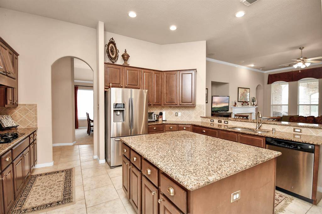 Abundant wood cabinets and ample counter space ensure that storage and serving are never an issue in this kitchen.
