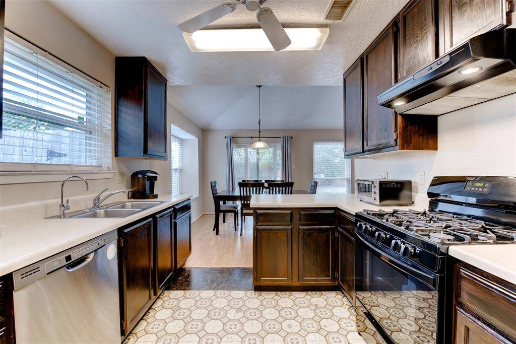 Alternate view of the kitchen showcases additional cabinet storage, expanded counter space perfect for meal prep, and a gas freestanding range ideal for cooking enthusiasts.
