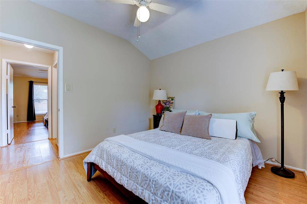 Alternate view of the generously sized secondary bedroom, which easily accommodates a king-size bed. A large front-facing window fills the space with natural light while maintaining a sense of privacy. A roomy closet provides excellent storage, and the sleek vinyl flooring throughout adds both durability and a clean, modern touch.