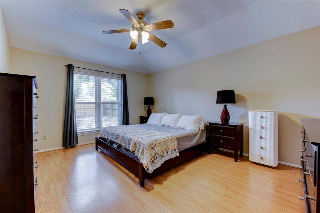 Alternate view of the primary bedroom. The space provides ample room for a variety of furniture configurations. An oversized double paned window floods the space with natural light, which works in combination with the ceiling fan and light kit to create a bright and comfortable retreat within the home.
