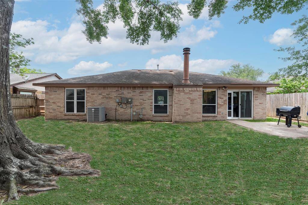 Spacious backyard with mature shade tree, privacy fencing, and plenty of room to play, garden, grill or entertain—an ideal outdoor retreat with direct access from the home.