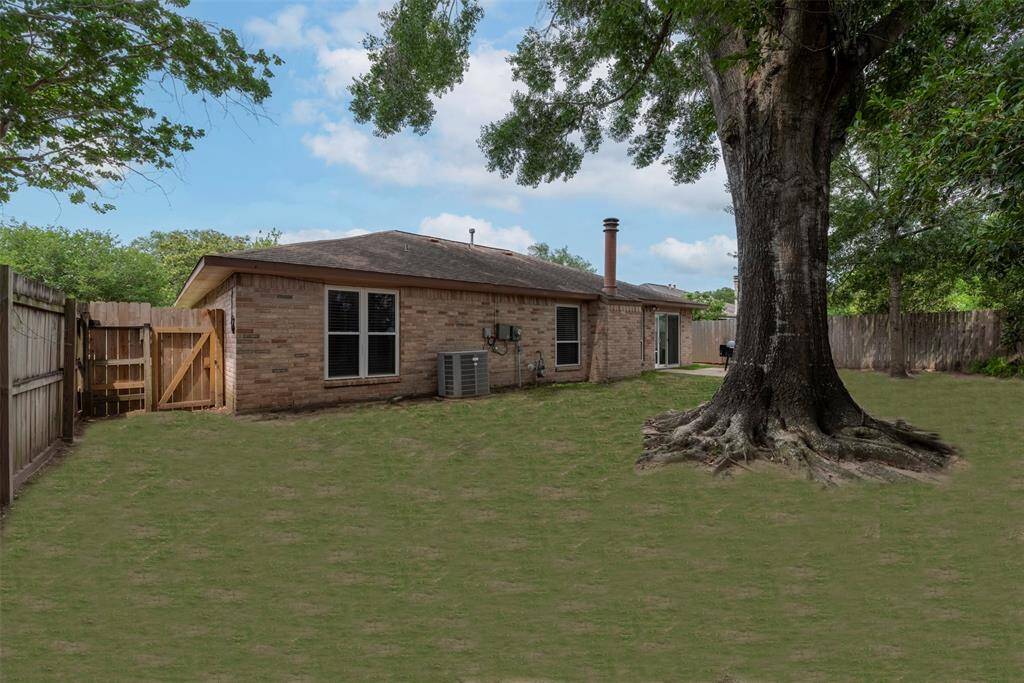 Spacious backyard with mature shade tree, privacy fencing, and plenty of room to play, garden, grill or entertain—an ideal outdoor retreat with direct access from the home.