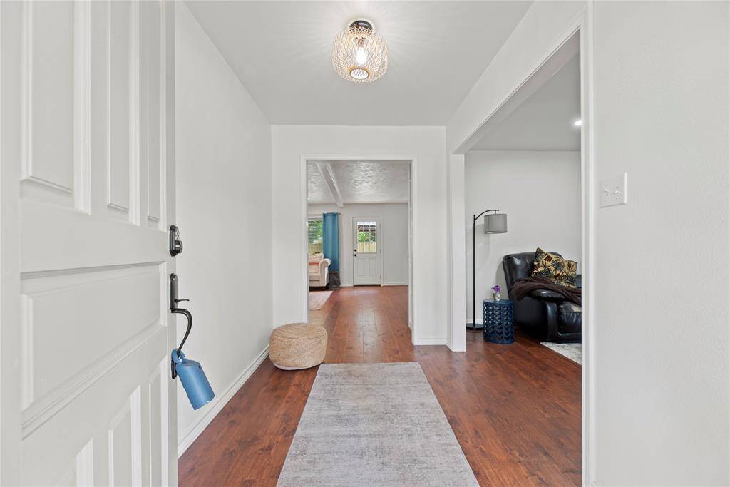Attractive front entry with laminate flooring and neutral paint.