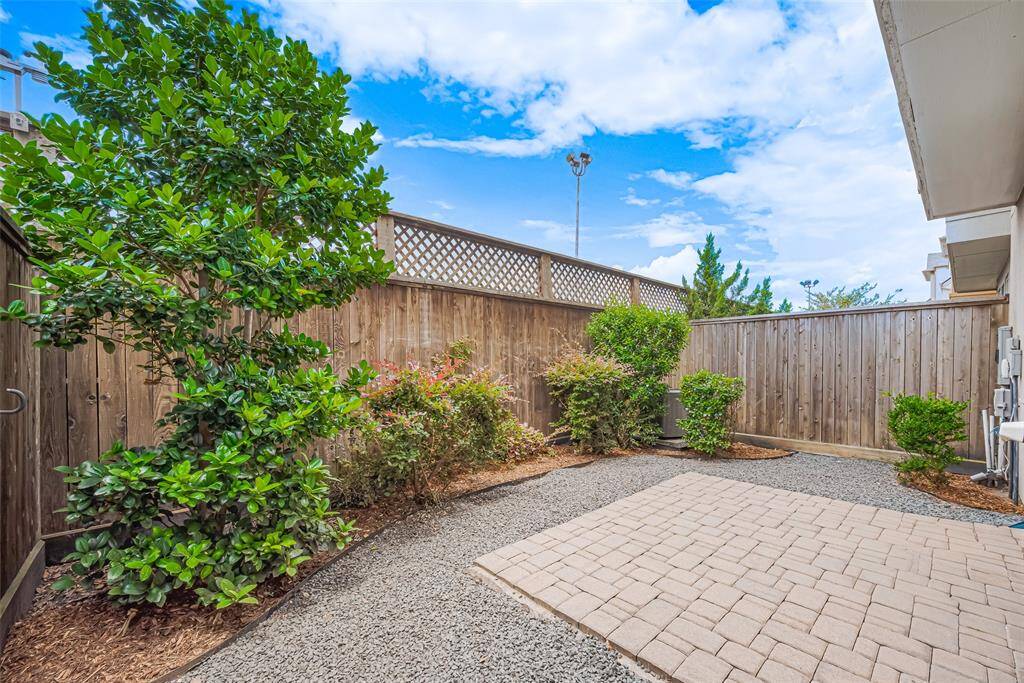 The backyard is fully fenced and features beautiful landscaping. Additionally, there is a Rain Bird sprinkler system in place to keep the shrubs looking lush and green.