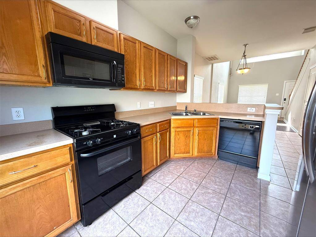 Kitchen with gas range and built in microwave.
