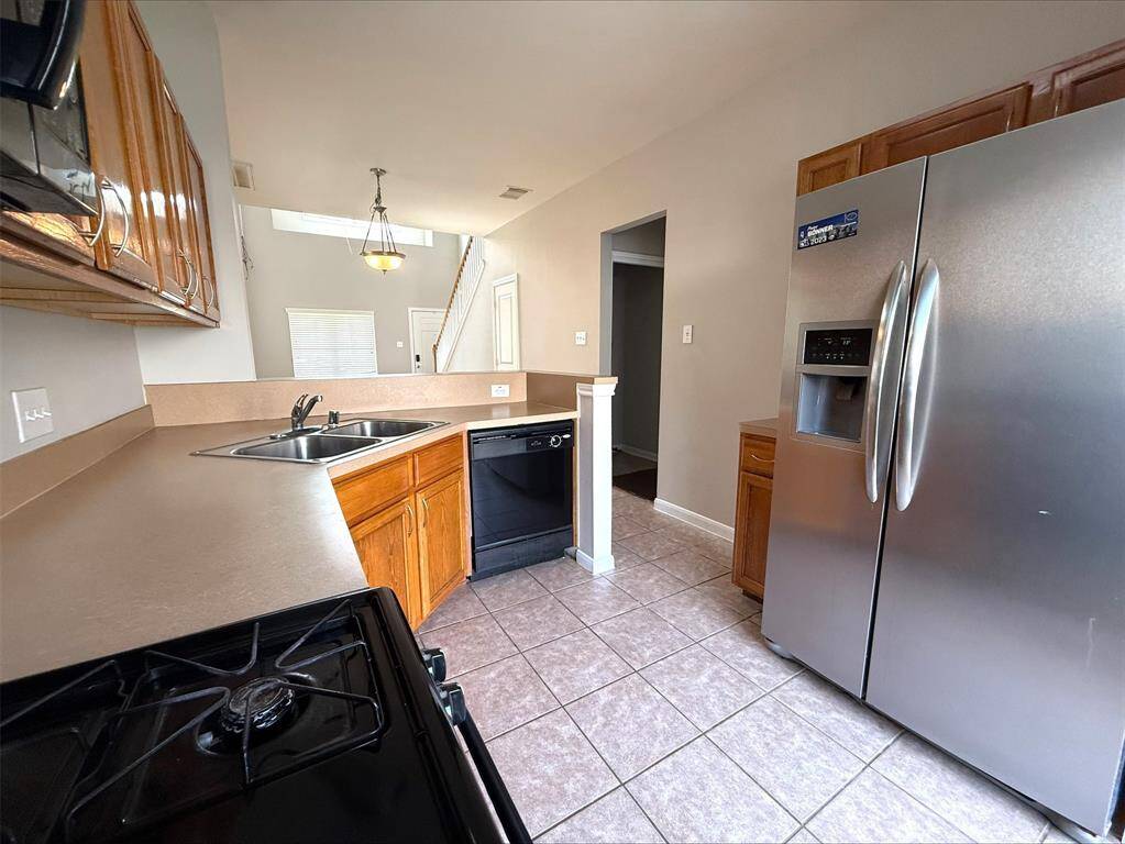 Kitchen with laminate counters. Refrigerator included.