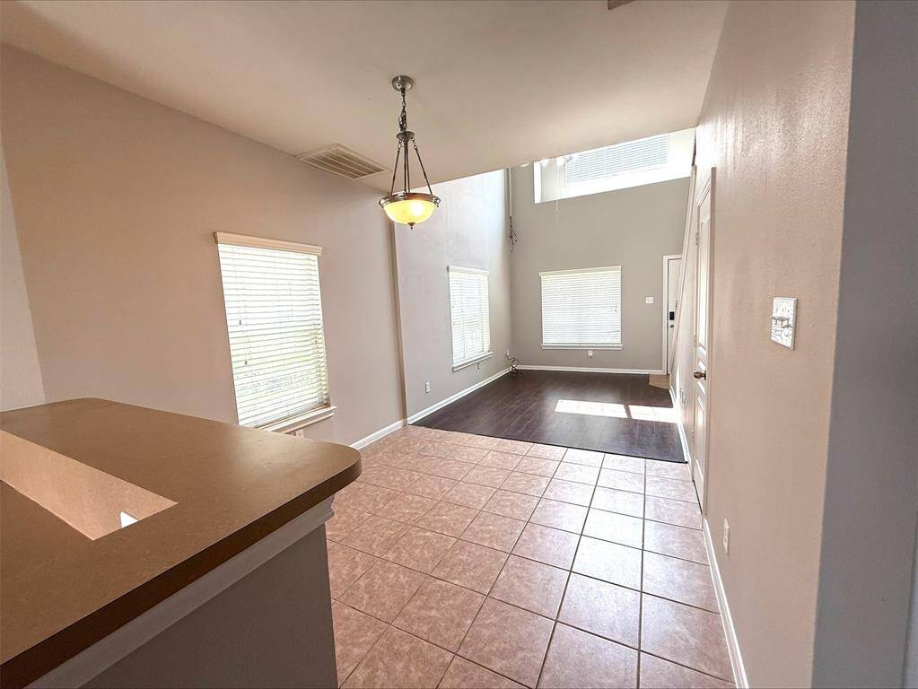 Alternate view of dining and living area. Laundry on the right.