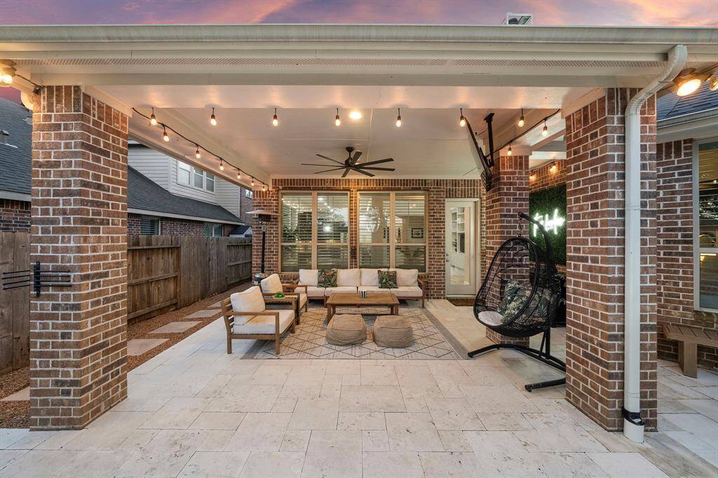 Covered outdoor retreat seamlessly blends indoor comfort with outdoor living for year-round enjoyment.