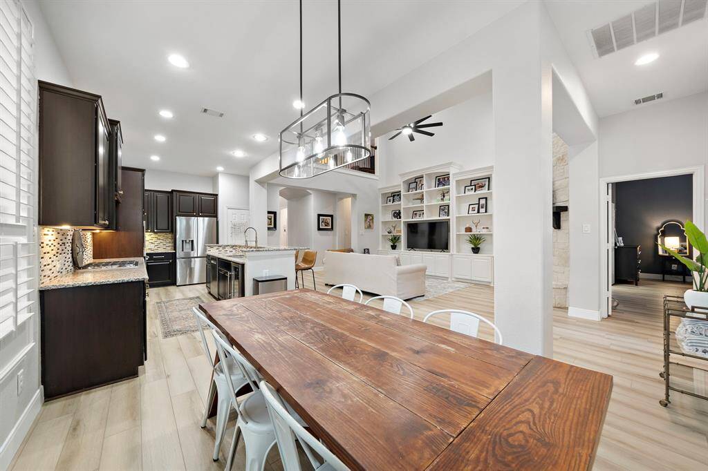 This well-appointed dining area is positioned between the kitchen and living room, allowing for a harmonious blend of casual dining and entertainment.