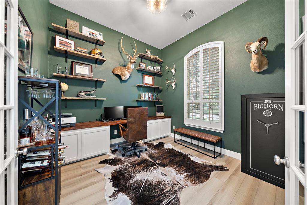 This home office is ready for business with high-end finishes and ample workspace.