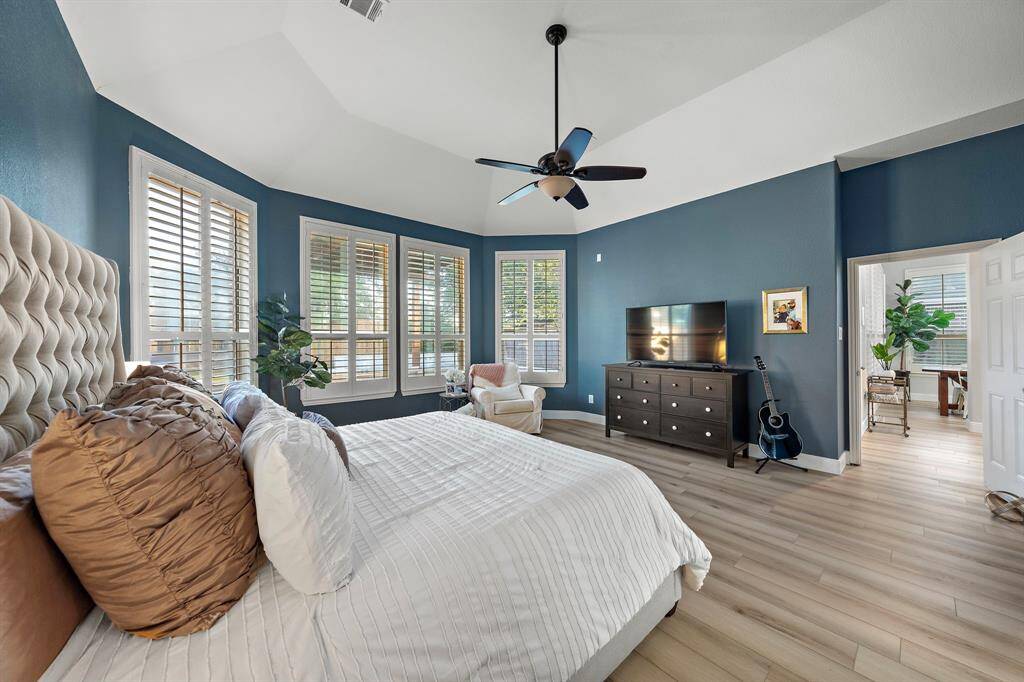 This tranquil primary bedroom offers comfort and space, with a perfect blend of style and function.