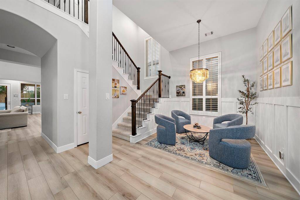 The soaring two-story foyer creates a grand entrance, welcoming you with natural light and open space.
