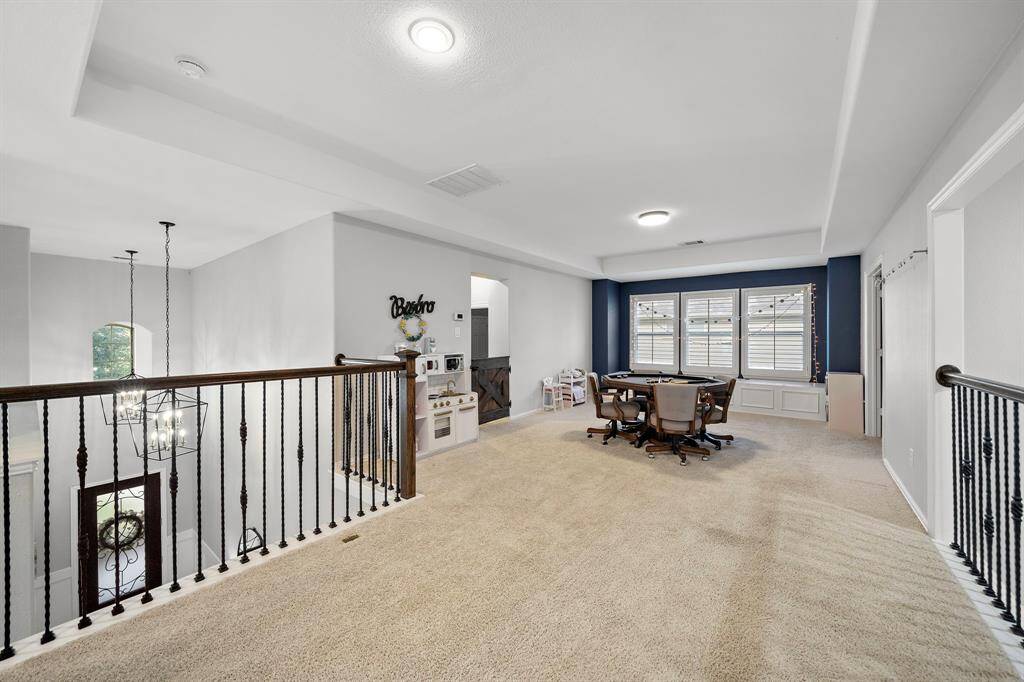 This versatile game room serves as a perfect space for family gatherings, game nights, or a home office setup.