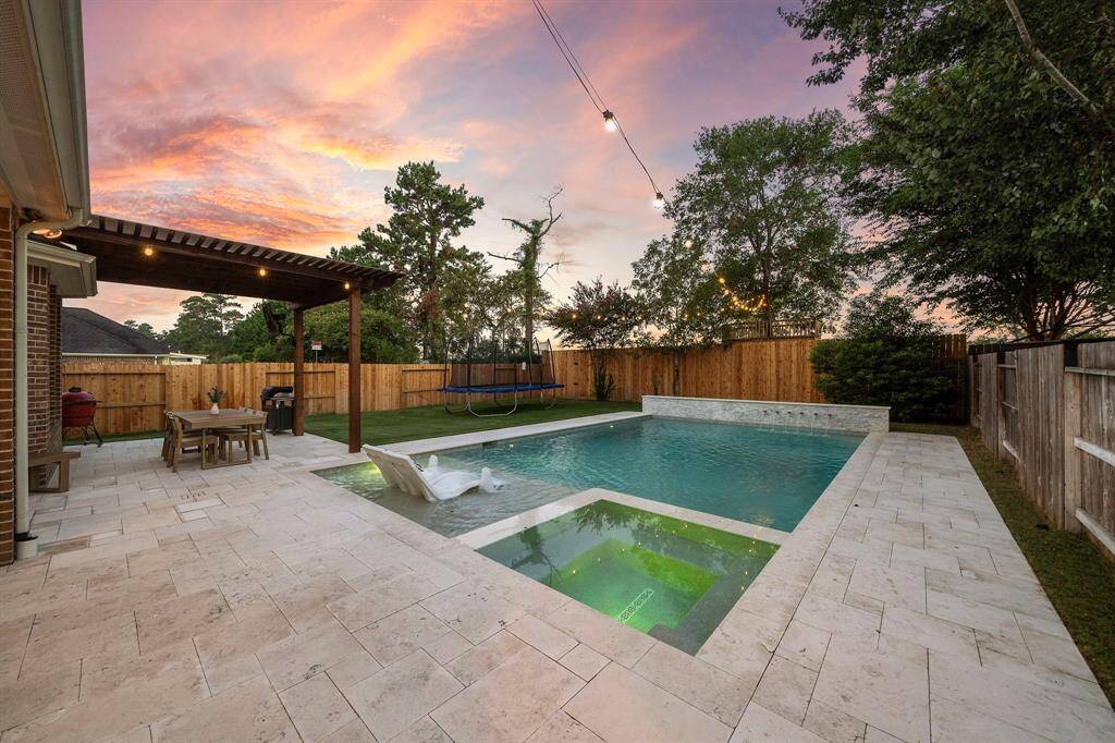 Take a refreshing swim or lounge poolside in this meticulously designed backyard retreat.