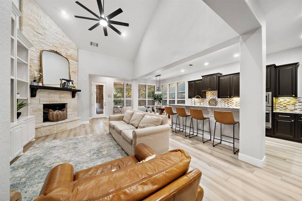 The stone fireplace serves as a gorgeous focal point, perfect for cozy nights in. Enjoy the perfect blend of style and comfort in this thoughtfully designed living space.