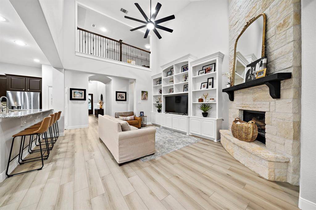 Seamlessly flowing from the kitchen, this living space offers the ideal layout for gatherings. Vaulted ceilings and recessed lighting create a bright and airy atmosphere.