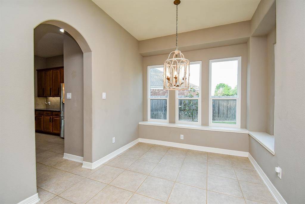 Breakfast area with two walls of windows. All the windows in the home are new and these single hung windows add elegance and bring in natural light.