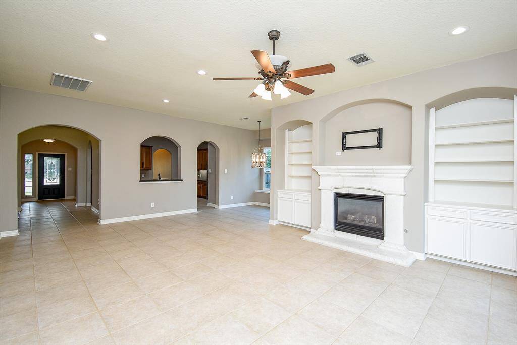 This desirable open concept floor plan is great for entertaining.  With custom built-in cabinets and shelves that bookend the gas fireplace, new recessed lights and new smart light switches add to the appeal.