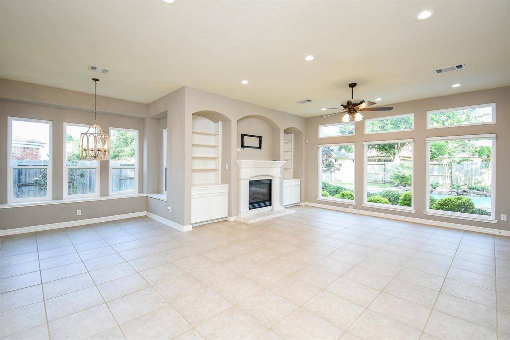 The new windows bring in tons of natural light and the picture windows in the family room show case the incredible back yard paradise.  New back door leading to resort style pool and patio area.  New WiFi remote blinds in family room.