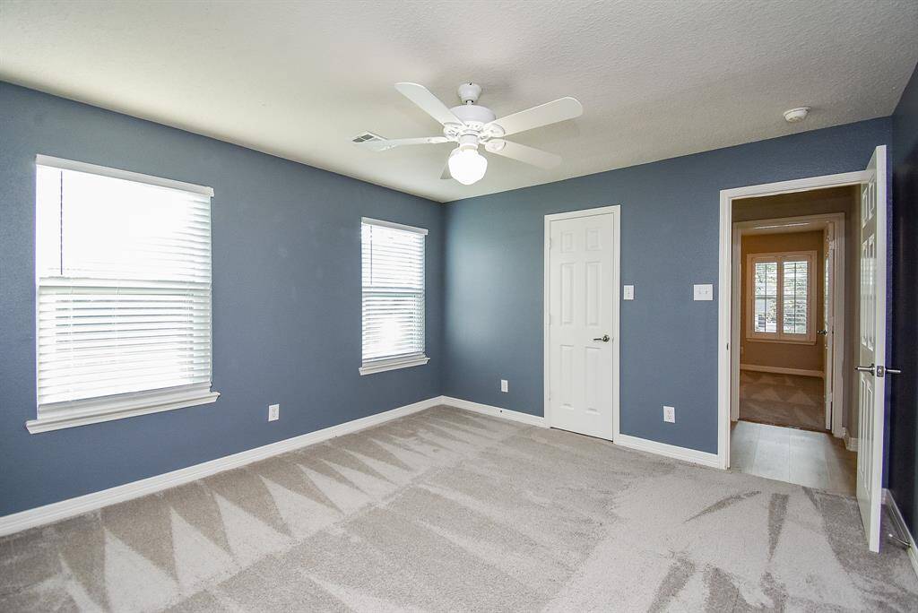 Custom paint and wall of windows lighten up a secondary bedroom upstairs.