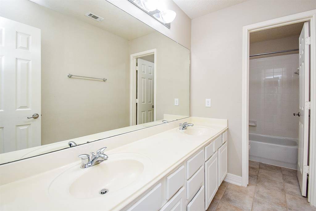 One secondary bathroom upstairs with dual sinks and separate water closet with shower/tub combo.