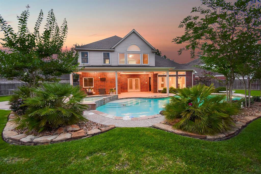 Beautiful scenery on your back patio gazing over the pool and lush landscaping.