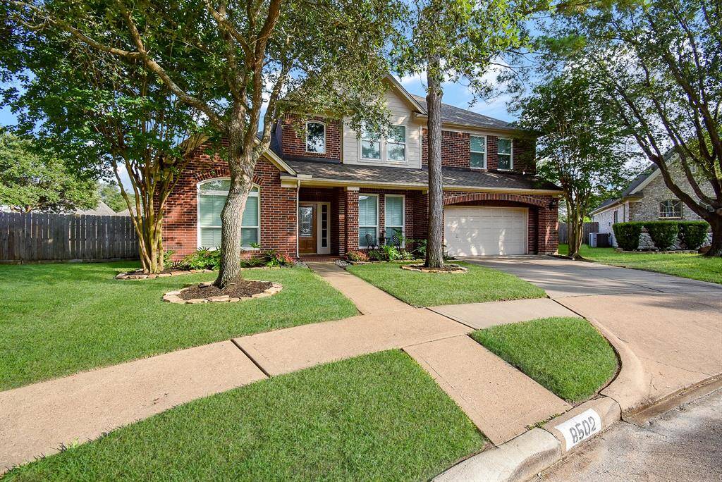 Large lot with wide driveway leading to oversized three car garage.