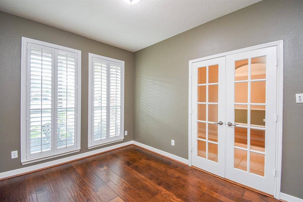 Desirable Shutters let in tons of natural light. French doors leading into the study off the entry way with desirable wide plank wood flooring.