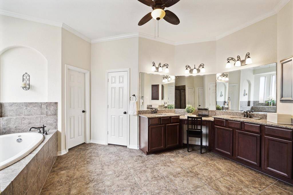 Spa-like primary bathroom showcasing a spacious layout featuring a large garden tub, perfectly positioned for relaxation, complemented by a generous separate shower with sleek glass enclosure.