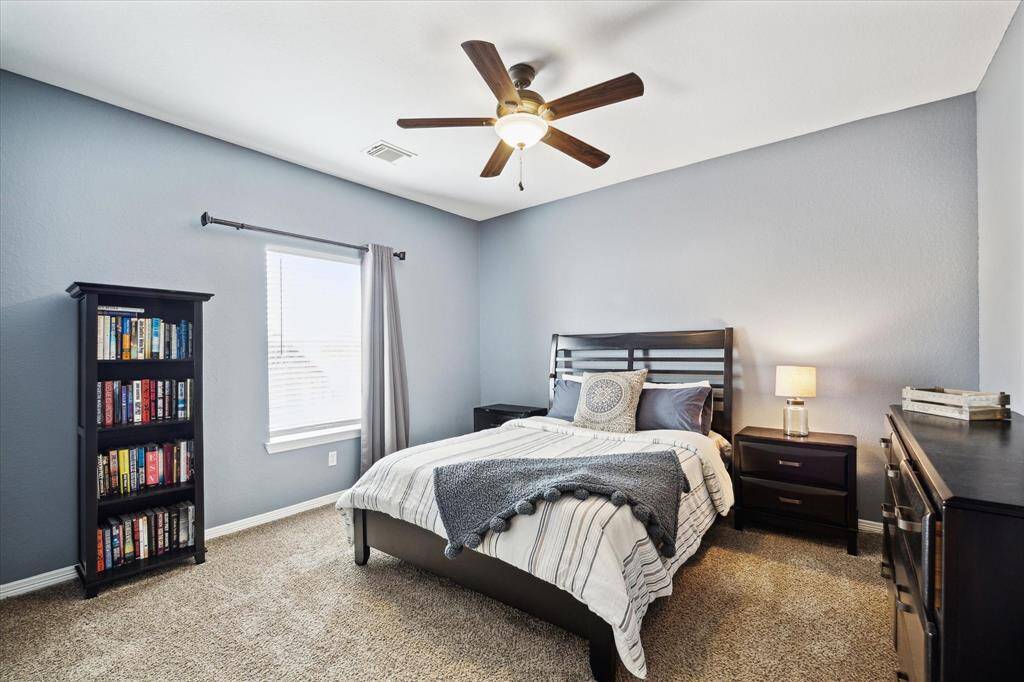 This inviting upstairs bedroom, one of three upstairs, features a generous layout with walk-in closet. This bedroom also benefits from its own separate full bath, offering privacy and convenience.