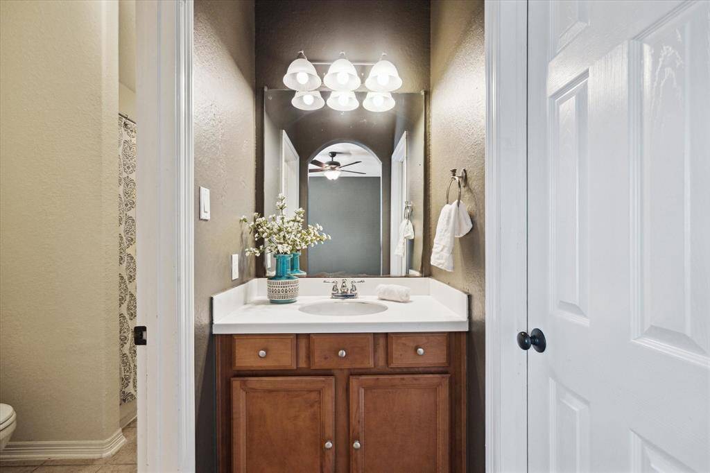Jack and Jill bathroom thoughtfully designed for convenience and privacy, featuring separate vanities for each adjoining bedroom and a shared tub/shower area. Ideal for siblings or guests, offering both functionality and personal space.