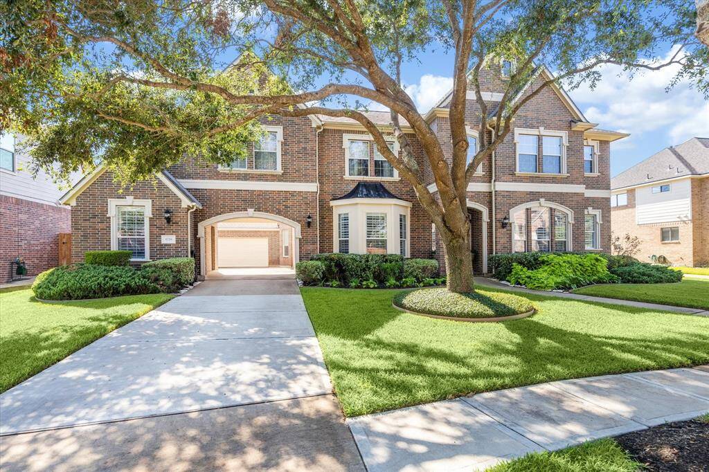 The long driveway leads to a 3-car garage, offering plenty of parking for multiple drivers or guests. The automated sprinkler system ensures effortless maintenance of the lush, mature landscaping—enhancing the home’s standout curb appeal year-round.