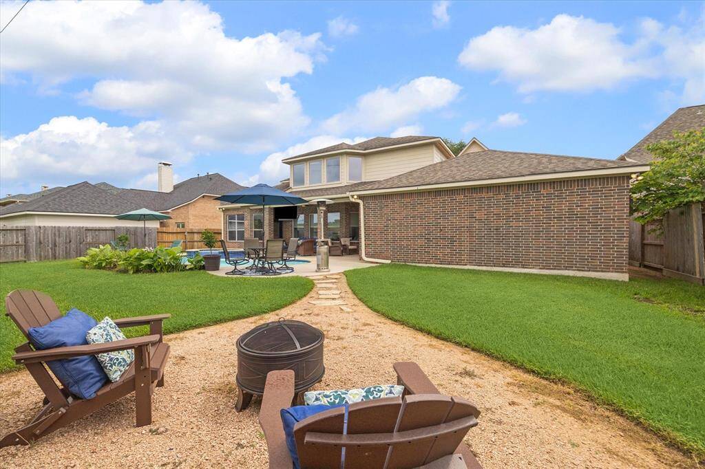 Cozy separate fire pit area offers the perfect spot for evening gatherings, roasting marshmallows, or relaxing under the stars. A charming addition to the outdoor living space!