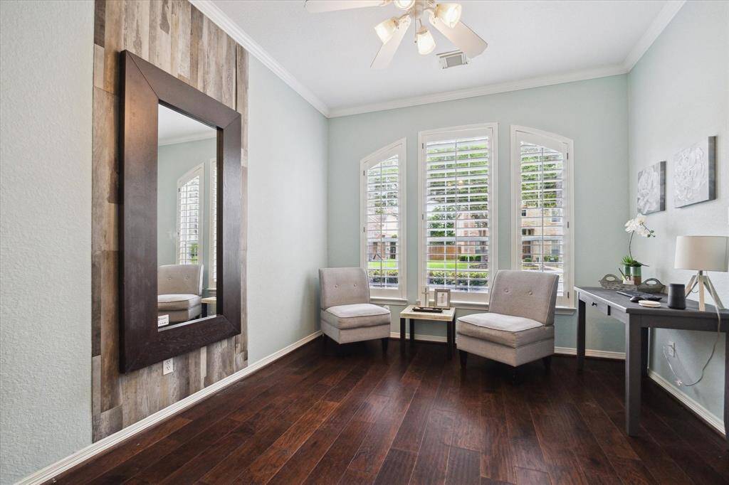 This versatile office space, ideal for conversion, features rich wood flooring and large windows with plantation shutters allowing ample natural light. Plumbed for water, this space can easily be transformed into a wine/bar room, wellness room, or 5th bedroom.